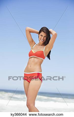 Picture - Portrait of a woman posing on the beach. Fotosearch