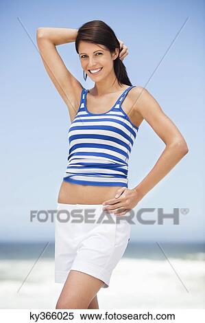 Stock Photography - Portrait of a woman posing on the beach. Fotosearch