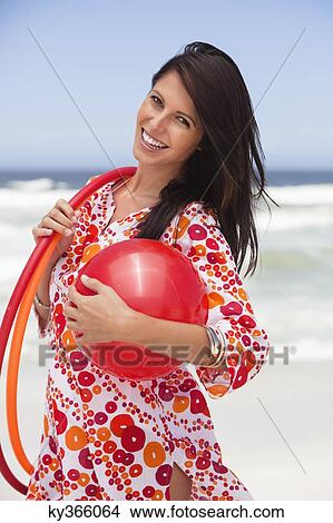 Portrait of a young woman carrying ball and plastic hoops View Large Photo Image Picture - Portrait of a young woman carrying ball and plastic hoops. Fotosearch