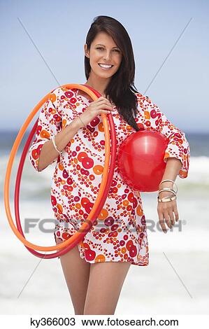 Portrait of a young woman carrying ball and plastic hoops View Large Photo Image Stock Image - Portrait of a young woman carrying ball and plastic hoops. Fotosearch