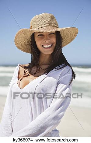 Portrait of a young woman smiling on the beach View Large Photo Image Picture - Portrait of a young woman smiling on the beach. Fotosearch