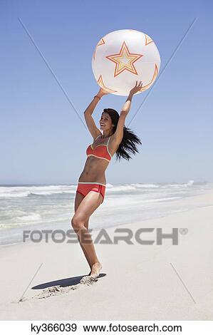 Woman playing with beach ball View Large Photo Image Stock Photo - Woman playing with beach ball. Fotosearch