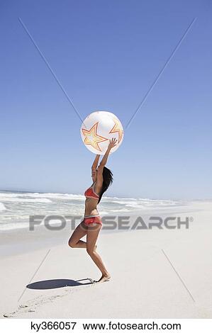 Woman playing with beach ball View Large Photo Image Stock Photo - Woman playing with beach ball. Fotosearch
