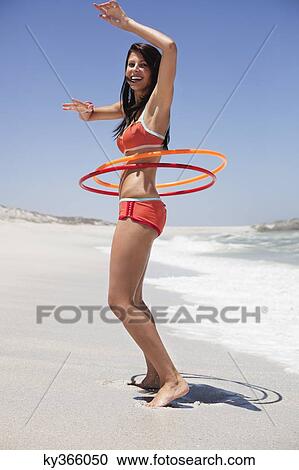 Woman playing with plastic hoops on the beach View Large Photo Image Stock Image - Woman playing with plastic hoops on the beach. Fotosearch