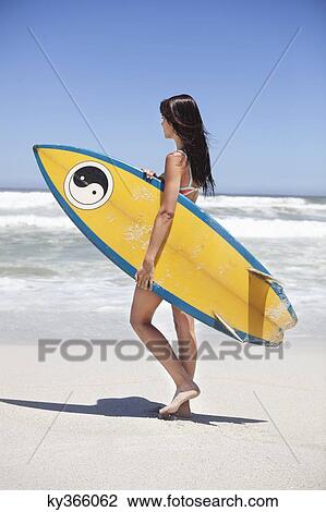 Woman walking on the beach with surfboard View Large Photo Image Stock Image - Woman walking on the beach with surfboard. Fotosearch