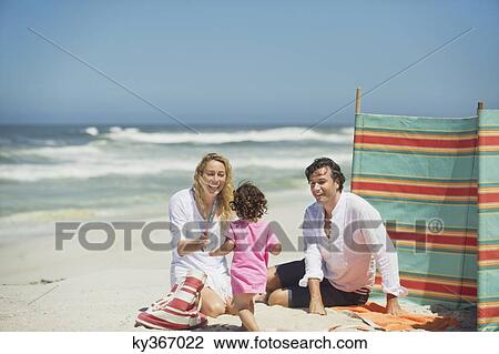 Stock Image - Family on the beach. Fotosearch