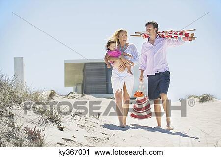 Family walking on the beach View Large Photo Image Stock Image - Family walking on the beach. Fotosearch