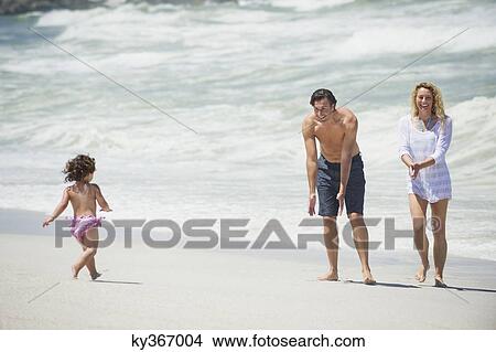 Happy family playing on the beach View Large Photo Image Picture - Happy family playing on the beach. Fotosearch