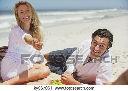 Mid adult couple on the beach View Large Photo Image Stock Image - Mid adult couple on the beach. Fotosearch