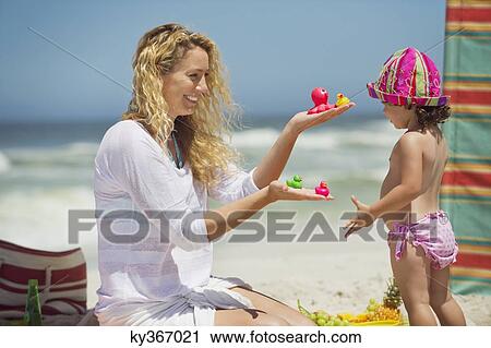 Stock Image - Woman giving toys to her daughter. Fotosearch