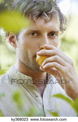 Close-up of a man smelling a lemon View Large Photo Image Stock Image - Close-up of a man smelling a lemon. Fotosearch