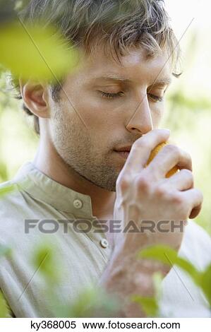 Close-up of a man smelling a lemon View Large Photo Image Stock Photography - Close-up of a man smelling a lemon. Fotosearch