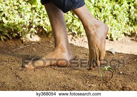 Picture - Low section view of a barefooted man. Fotosearch