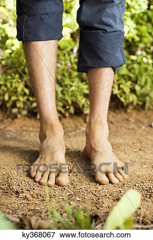 Low section view of a barefooted man View Large Photo Image Stock Photo - Low section view of a barefooted man. Fotosearch