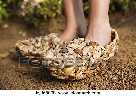 Low section view of a woman wearing wicker shoe View Large Photo Image Stock Photo - Low section view of a woman wearing wicker shoe. Fotosearch