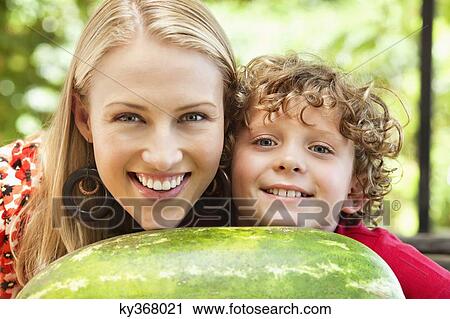 Mother and son leaning on watermelon View Large Photo Image Stock Image - Mother and son leaning on watermelon. Fotosearch