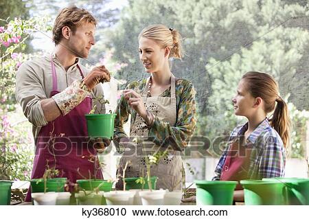 Parents and daughter gardening View Large Photo Image Stock Image - Parents and daughter gardening. Fotosearch