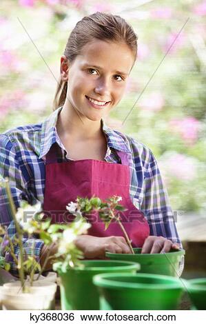Portrait of a girl gardening and smiling View Large Photo Image Stock Photograph - Portrait of a girl gardening and smiling. Fotosearch