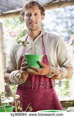 Portrait of a man gardening and smiling View Large Photo Image Picture - Portrait of a man gardening and smiling. Fotosearch