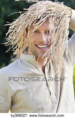 Portrait of a man standing in a field as scarecrow View Large Photo Image Stock Photo - Portrait of a man standing in a field as scarecrow. Fotosearch