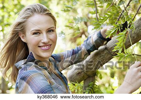 Portrait of a woman pruning plants View Large Photo Image Stock Photograph - Portrait of a woman pruning plants. Fotosearch