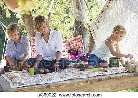 Children eating food in tree house View Large Photo Image Stock Image - Children eating food in tree house. Fotosearch