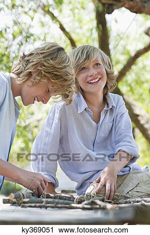Children making frame of driftwood outdoors View Large Photo Image Stock Image - Children making frame of driftwood outdoors. Fotosearch
