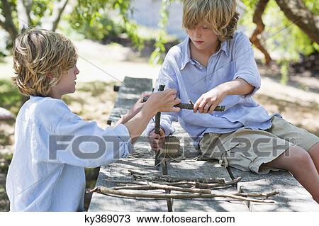 Children making frame of driftwood outdoors View Large Photo Image Stock Image - Children making frame of driftwood outdoors. Fotosearch