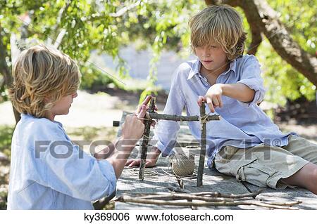 Children making frame of driftwood outdoors View Large Photo Image Stock Photograph - Children making frame of driftwood outdoors. Fotosearch