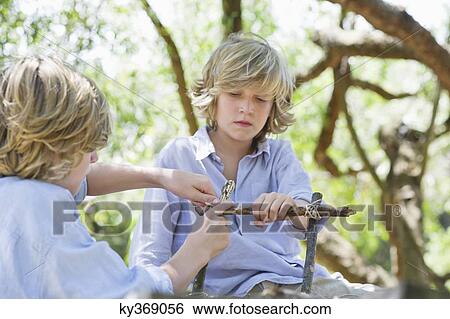 Children making frame of driftwood outdoors View Large Photo Image Stock Photograph - Children making frame of driftwood outdoors. Fotosearch