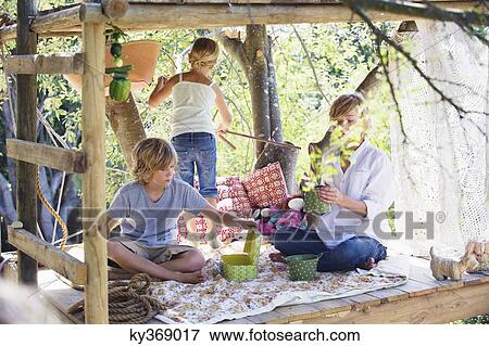 Stock Photo - Children playing in tree house. Fotosearch