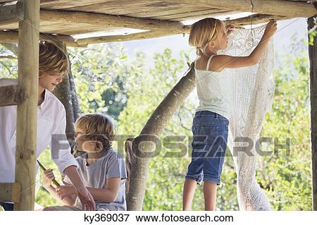 Children playing in tree house View Large Photo Image Stock Photo - Children playing in tree house. Fotosearch