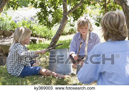 Children playing music on kitchen stuff back yard View Large Photo Image Stock Image - Children playing music on kitchen stuff back yard. Fotosearch