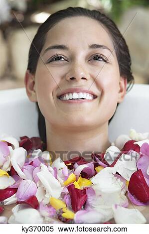 Beautiful young woman relaxing in bathtub with petals View Large Photo Image Stock Photography - Beautiful young woman relaxing in bathtub with petals. Fotosearch