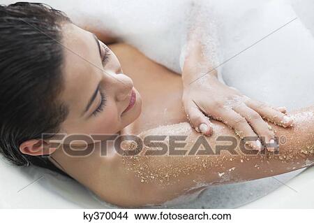 Beautiful young woman taking bubble bath View Large Photo Image Picture - Beautiful young woman taking bubble bath. Fotosearch