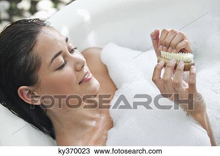 Beautiful young woman taking bubble bath View Large Photo Image Stock Image - Beautiful young woman taking bubble bath. Fotosearch