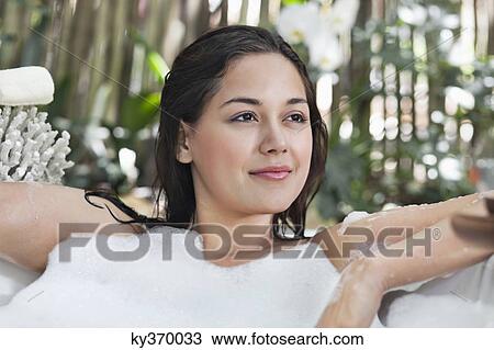 Beautiful young woman taking bubble bath View Large Photo Image Stock Image - Beautiful young woman taking bubble bath. Fotosearch