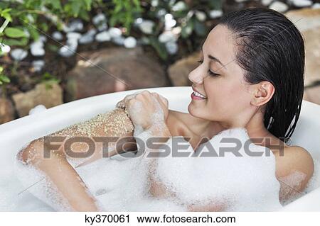 Beautiful young woman taking bubble bath View Large Photo Image Stock Image - Beautiful young woman taking bubble bath. Fotosearch