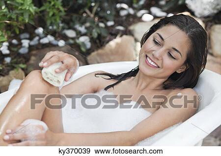 Beautiful young woman taking bubble bath View Large Photo Image Stock Photo - Beautiful young woman taking bubble bath. Fotosearch
