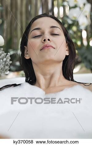 Beautiful young woman taking bubble bath View Large Photo Image Stock Photo - Beautiful young woman taking bubble bath. Fotosearch