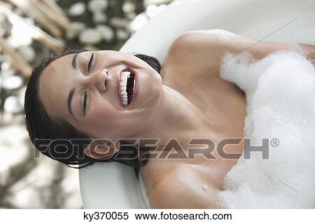 Beautiful young woman taking bubble bath and smiling View Large Photo Image Stock Photography - Beautiful young woman taking bubble bath and smiling. Fotosearch