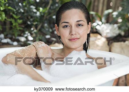 Portrait of a beautiful young woman taking bubble bath View Large Photo Image Stock Photo - Portrait of a beautiful young woman taking bubble bath. Fotosearch