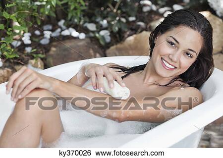 Portrait of a beautiful young woman taking bubble bath View Large Photo Image Stock Photograph - Portrait of a beautiful young woman taking bubble bath. Fotosearch