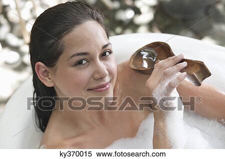 Portrait of a beautiful young woman taking bubble bath View Large Photo Image Stock Photography - Portrait of a beautiful young woman taking bubble bath. Fotosearch