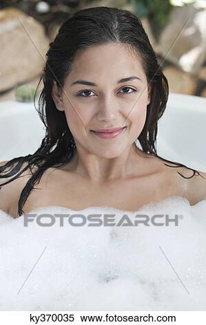 Portrait of a beautiful young woman taking bubble bath View Large Photo Image Stock Photography - Portrait of a beautiful young woman taking bubble bath. Fotosearch