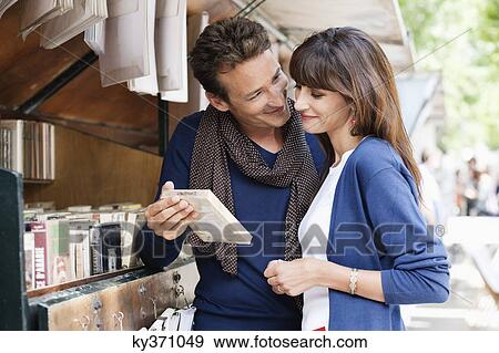 Couple at a book stall, Paris, Ile-de-France, France View Large Photo Image Stock Photo - Couple at a book stall, Paris, Ile-de-France, France. Fotosearch