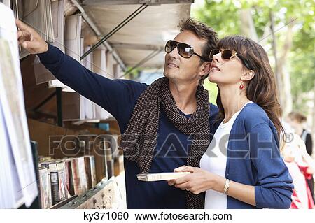 Couple choosing books at a book stall, Paris, Ile-de-France, France View Large Photo Image Stock Image - Couple choosing books at a book stall, Paris, Ile-de-France, France. Fotosearch