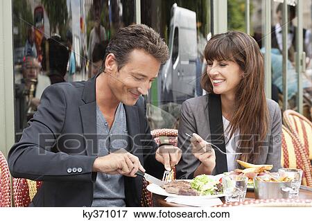 Couple enjoying lunch at a restaurant, Paris, Ile-de-France, France View Large Photo Image Stock Photo - Couple enjoying lunch at a restaurant, Paris, Ile-de-France, France. Fotosearch