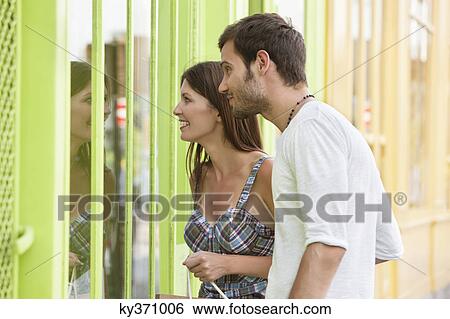 Couple looking at the display window of a store, Paris, Ile-de-France, France View Large Photo Image Stock Photograph - Couple looking at the display window of a store, Paris, Ile-de-France, France. Fotosearch