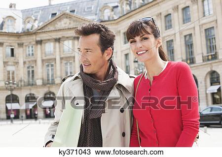 Stock Image - Couple on a street, Paris, Ile-de-France, France. Fotosearch